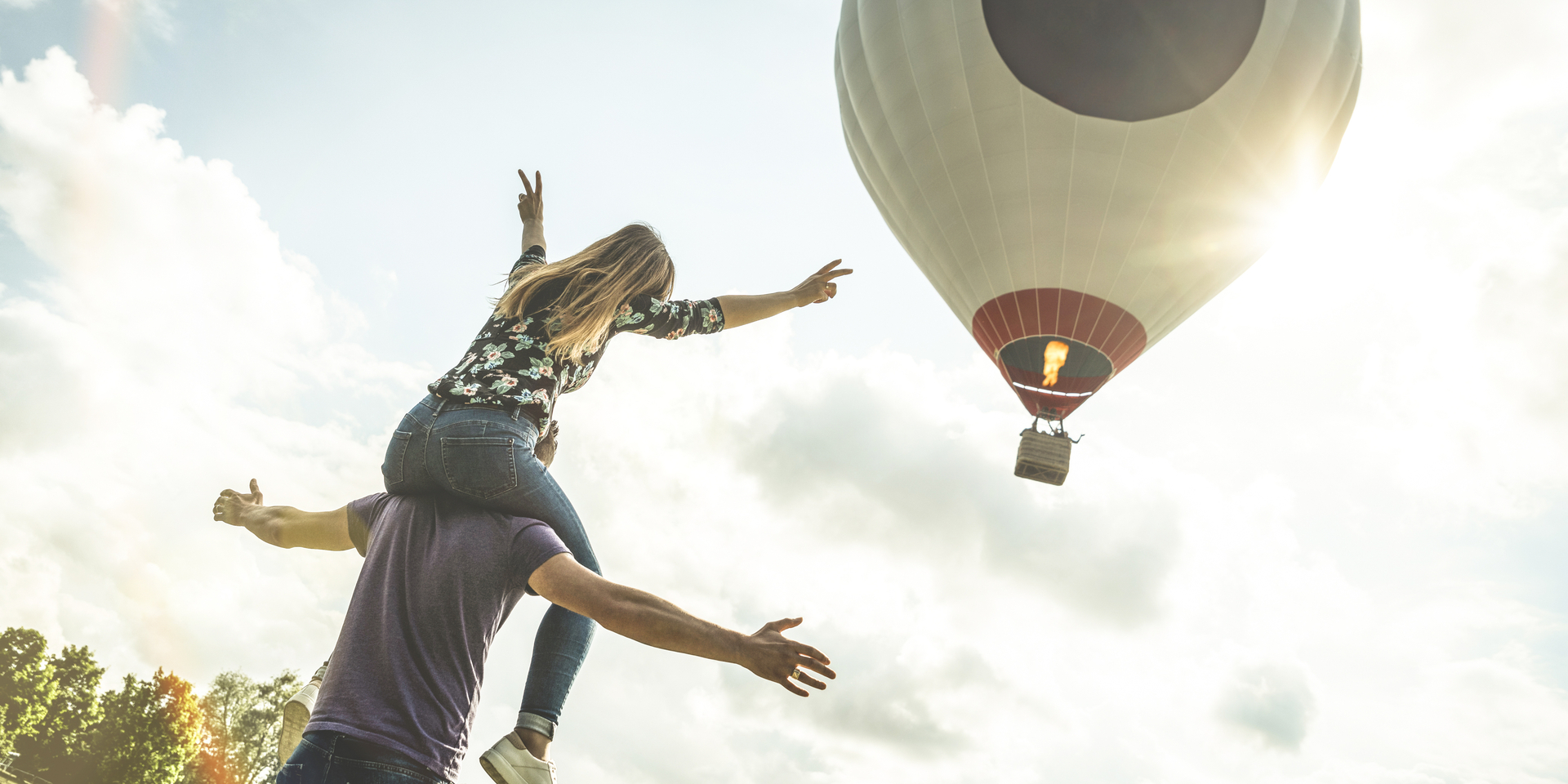 Couple watching a rising hot air balloon