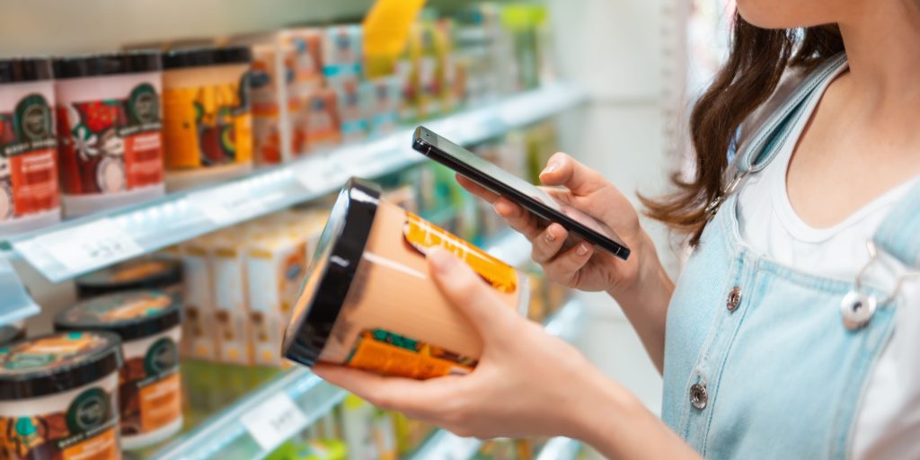 A woman scanning a cosmetics product with her phone