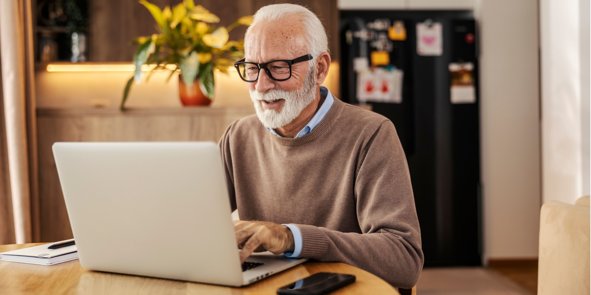 Senior man smiling as he works at home